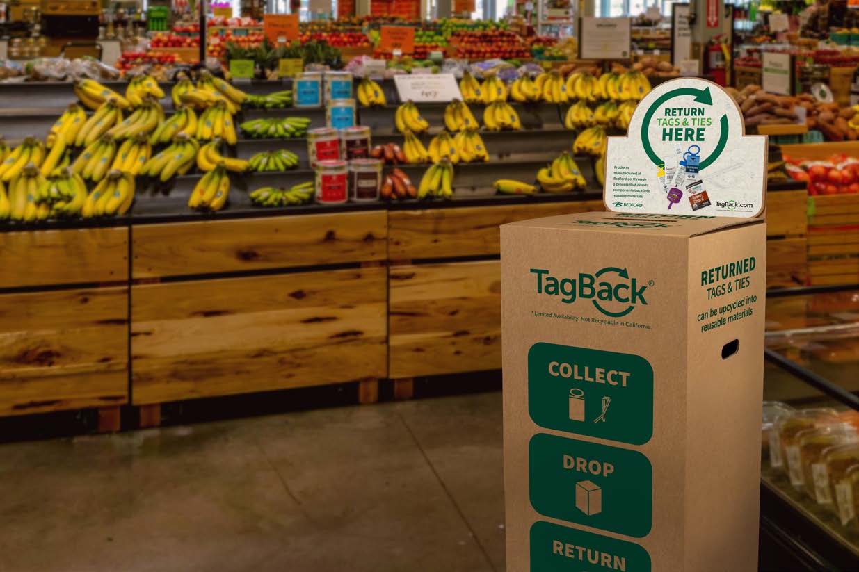 TagBack collection box in a grocery store produce section, used to return tags and ties for recycling