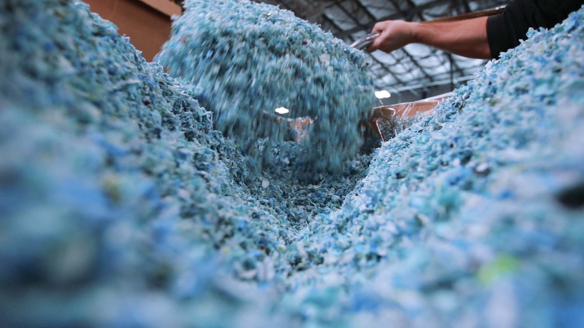 Reprocessed plastic regrind material moving through Bedford's material recovery process